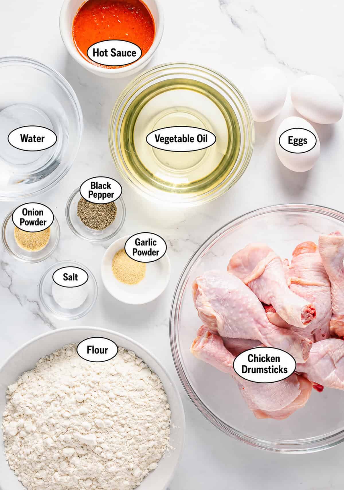 Labeled ingredients for Crispy Southern Fried Chicken Without Buttermilk including chicken eggs water buffalo sauce self rising flour salt pepper garlic and onion powders.