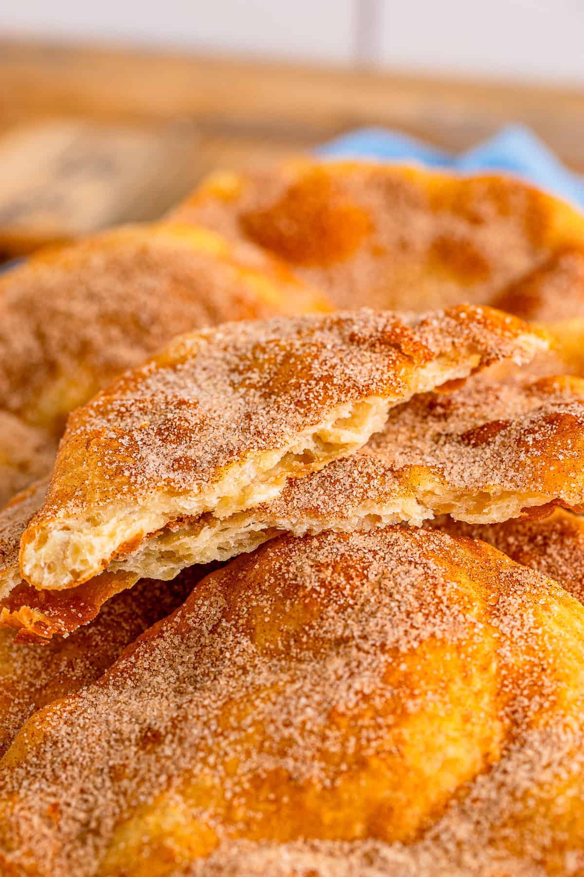 Close up of Elephant Ears with cinnamon sugar coating showing the crispy fried texture.