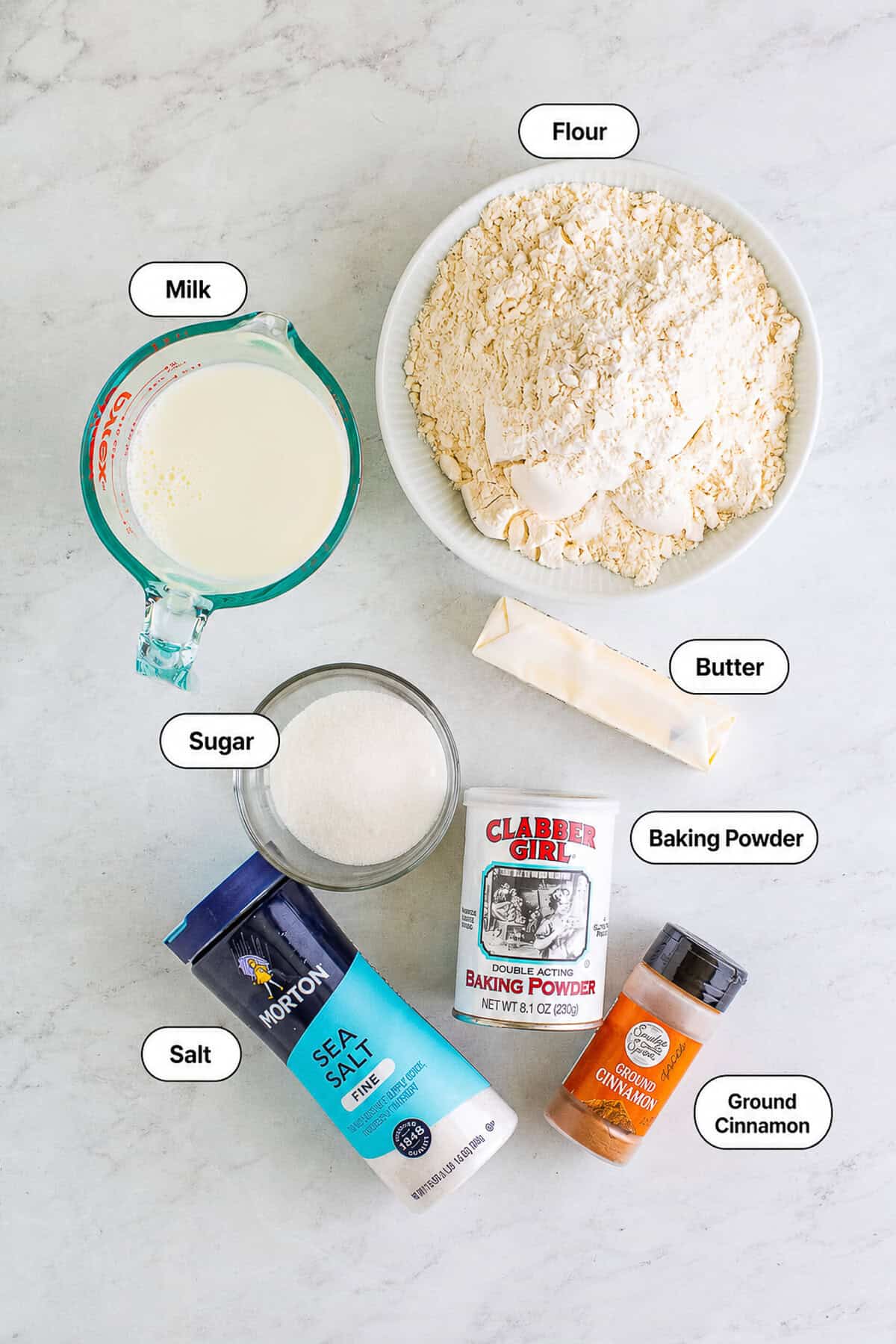 Labeled ingredients for Homemade Elephant Ears Recipe including flour milk butter sugar cinnamon baking powder salt and peanut oil.
