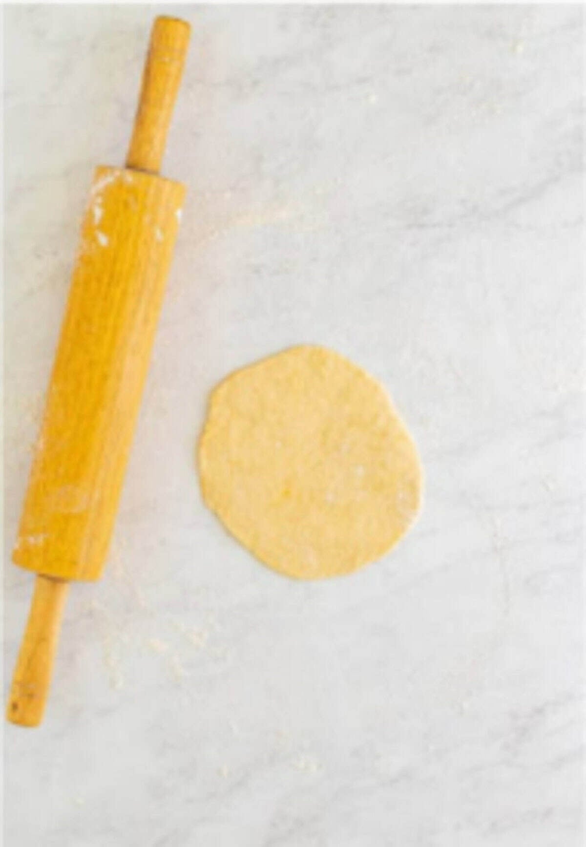 Dough divided into 8 portions and rolled out into thin circles dusted with flour for Homemade Elephant Ears.