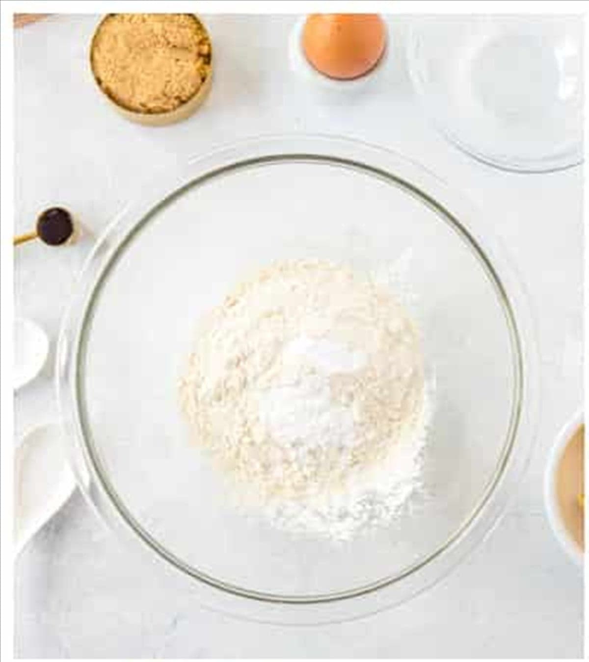 Flour, baking powder, baking soda, and salt mixed in a bowl for fig newton dough.