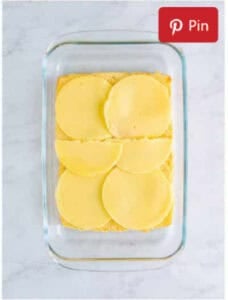 Bottom halves of Hawaiian rolls placed in a baking dish for French Dip Sliders.