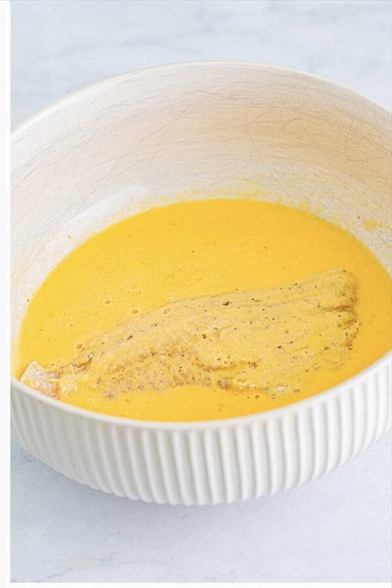 Catfish filet dredged in egg and buttermilk mixture for fried catfish recipe.