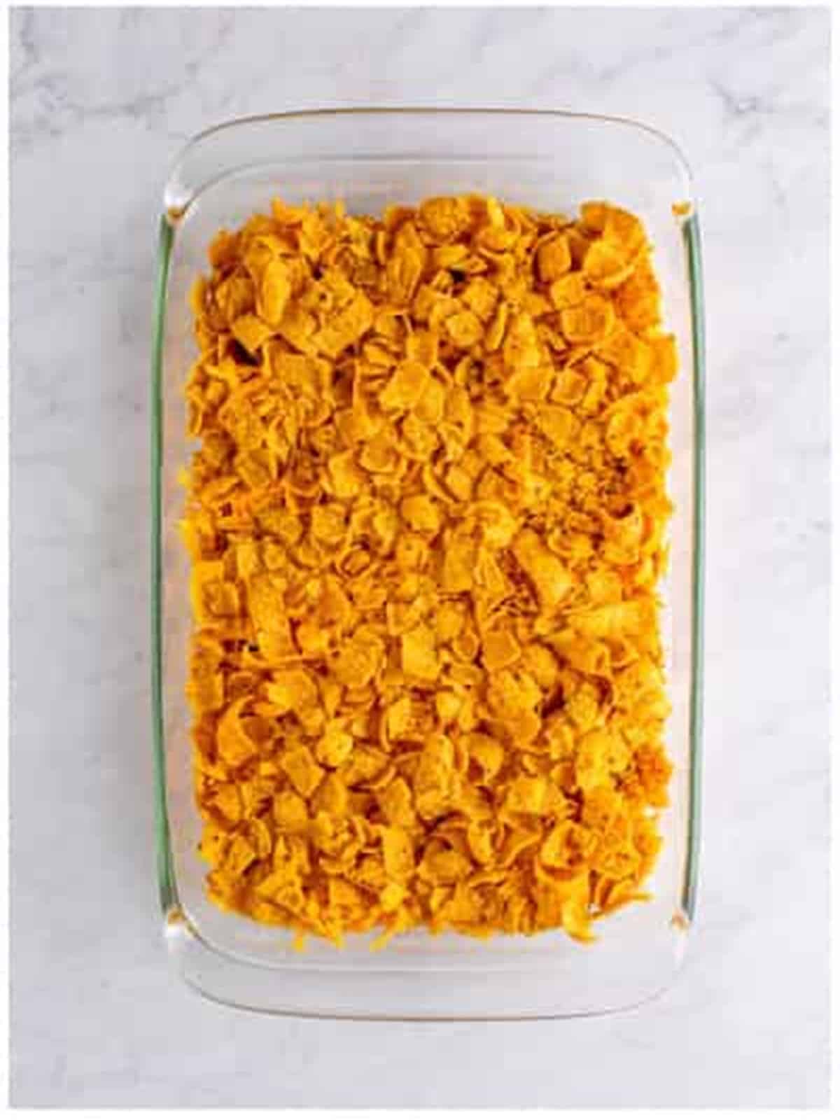A second layer of crushed Fritos and chili added to the casserole.