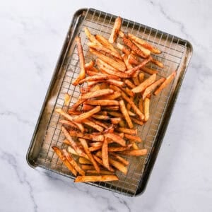 Second fry of Homemade French Fries at 375 degrees until golden brown then seasoning with salt.