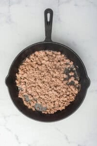 Ground beef cooked down into a finely textured base in the skillet, ready for the Coney Sauce Recipe spices and condiments.