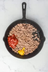 Coney Sauce Recipe simmering in the pan after the sauce and spices are stirred in, beef evenly coated and starting to thicken.