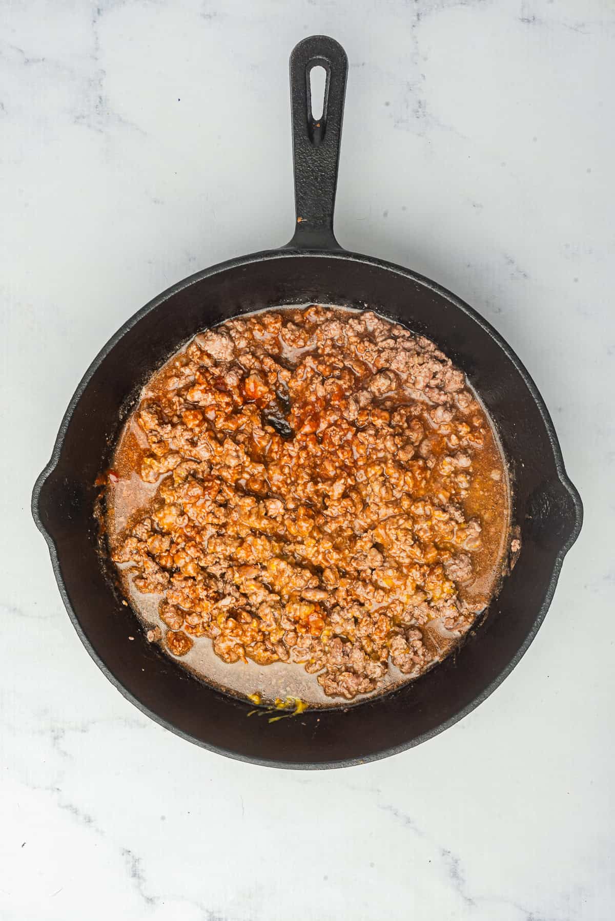 Hot Dog Sauce partway through its simmer with a few tablespoons of water added to keep the texture smooth and spreadable.