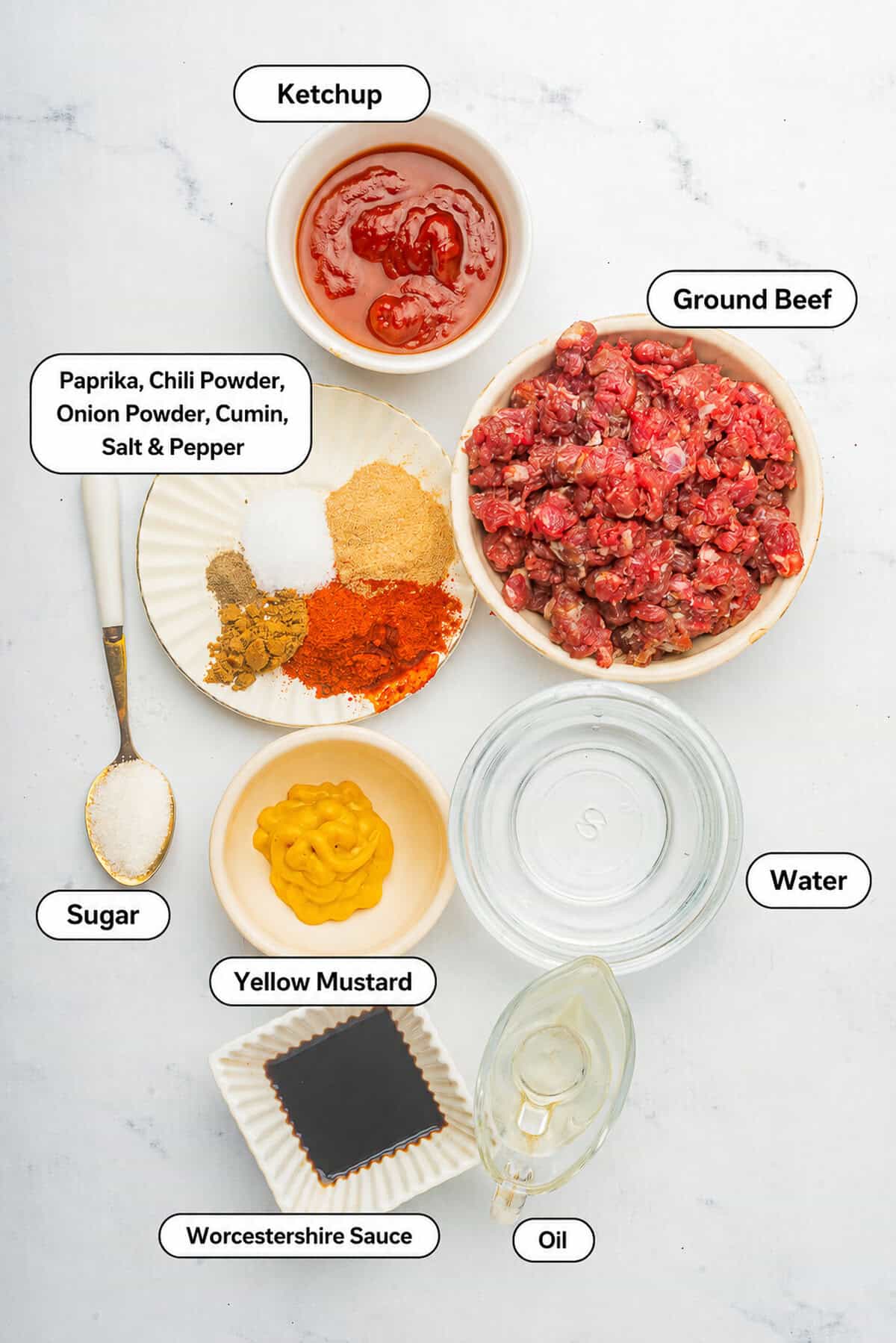 Hot Dog Sauce ingredients laid out on a marble board: ground beef, ketchup, mustard, vinegar, Worcestershire sauce, and spices including sweet paprika.