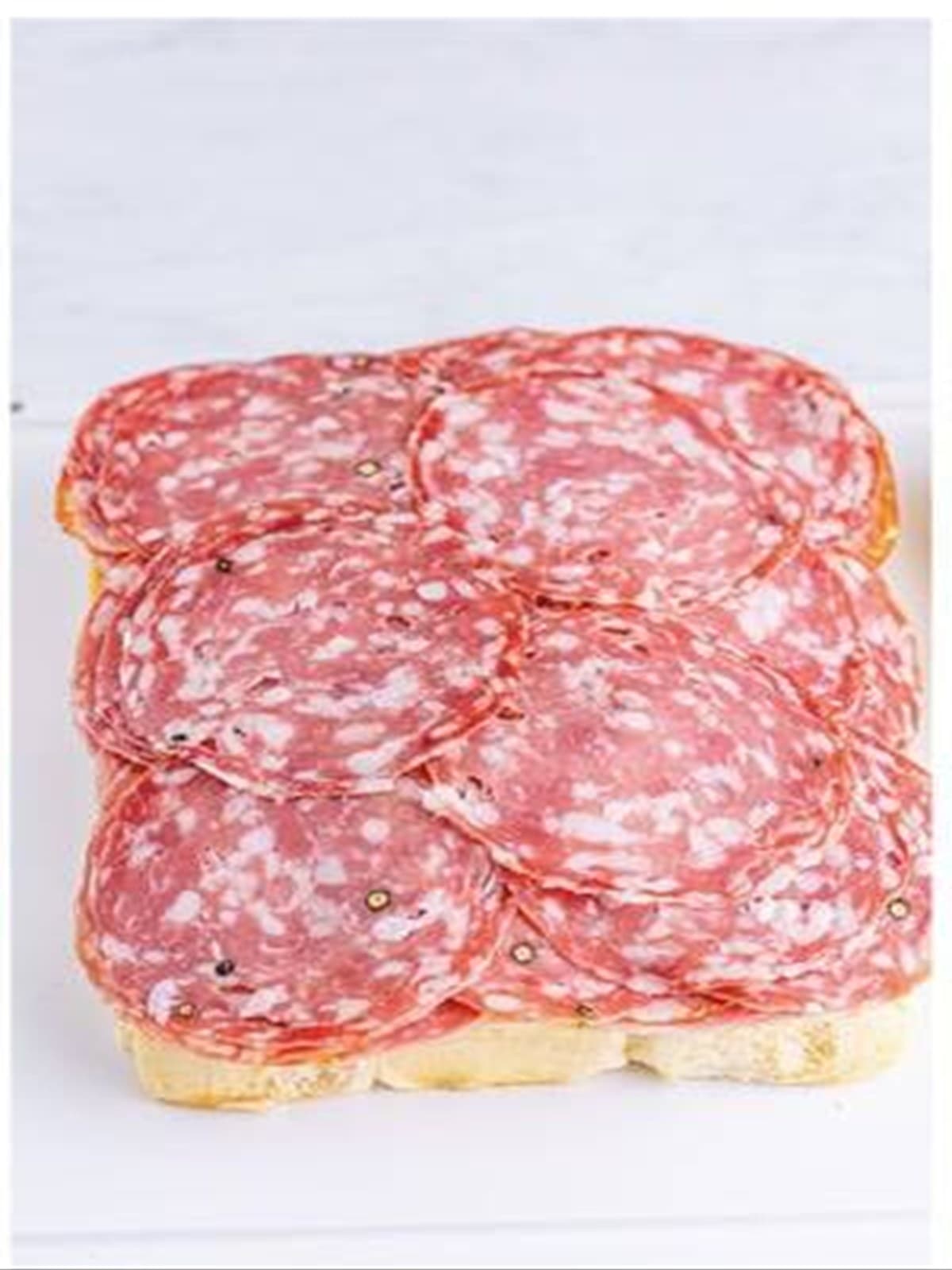 Provolone, pepperoni, salami, capocollo, and soppressata layered on the rolls for Italian sliders.