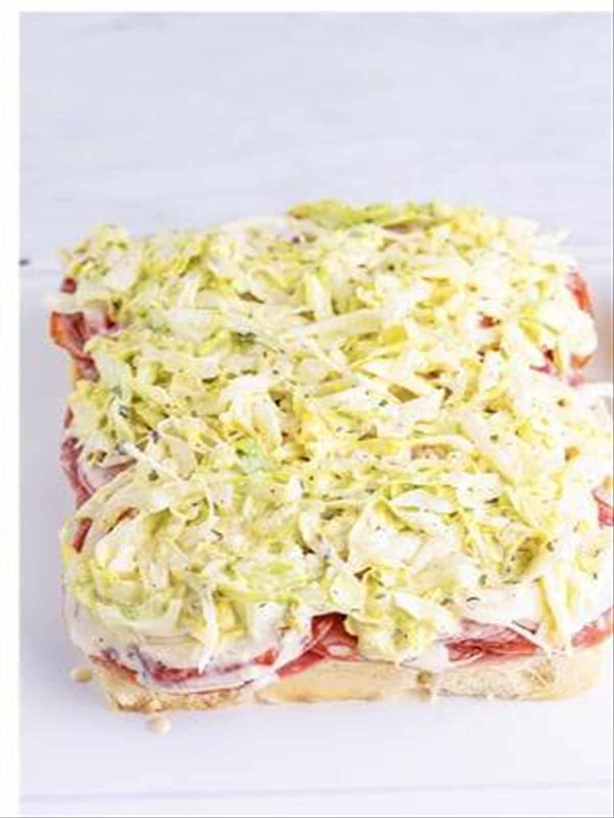 Shredded dressed lettuce added on top of the Italian slider fillings.