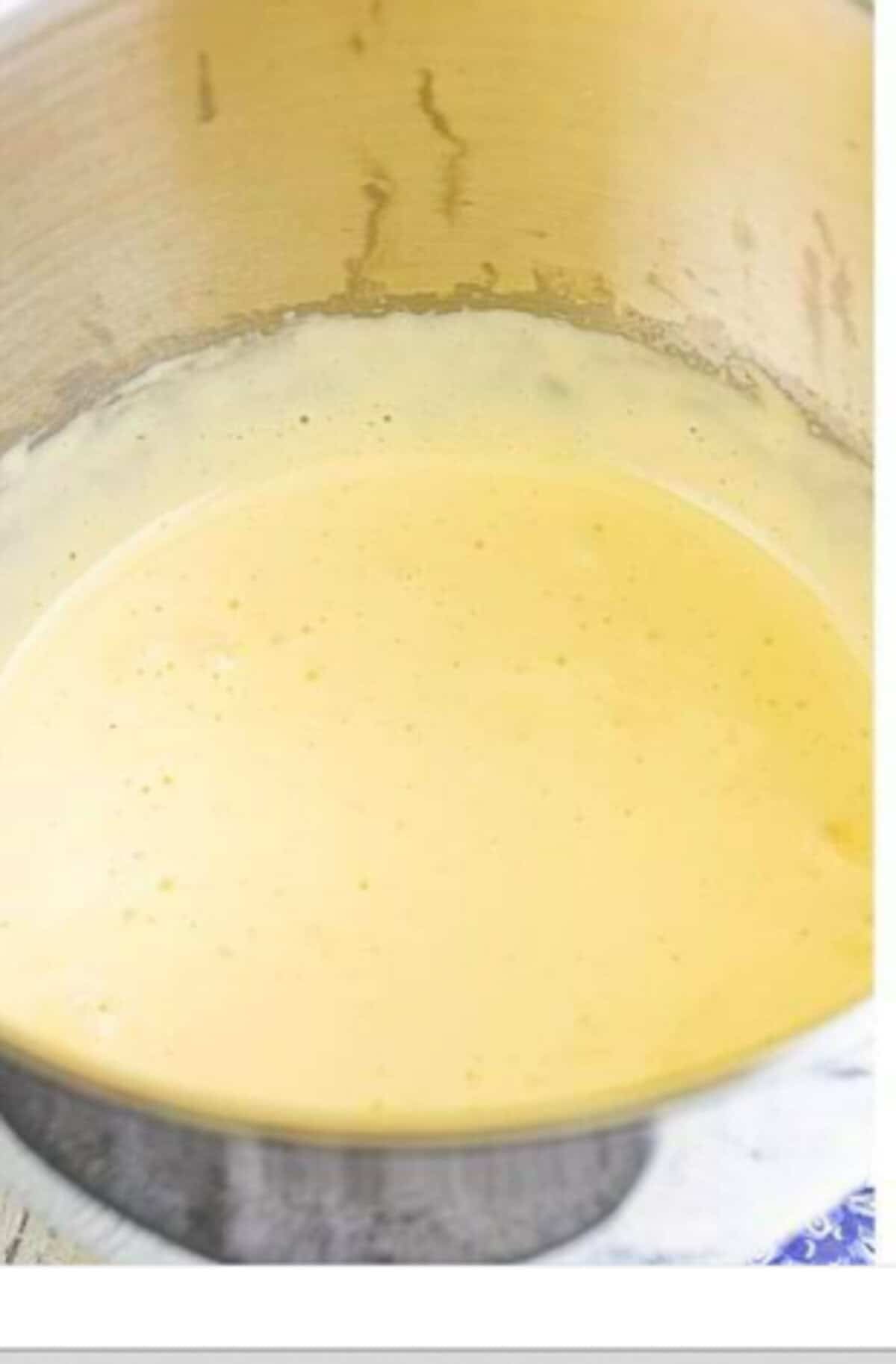 An instant-read thermometer in the egg mixture showing 165 degrees Fahrenheit, the food-safe target temperature for the Homemade Lady Finger Cookies Recipe.