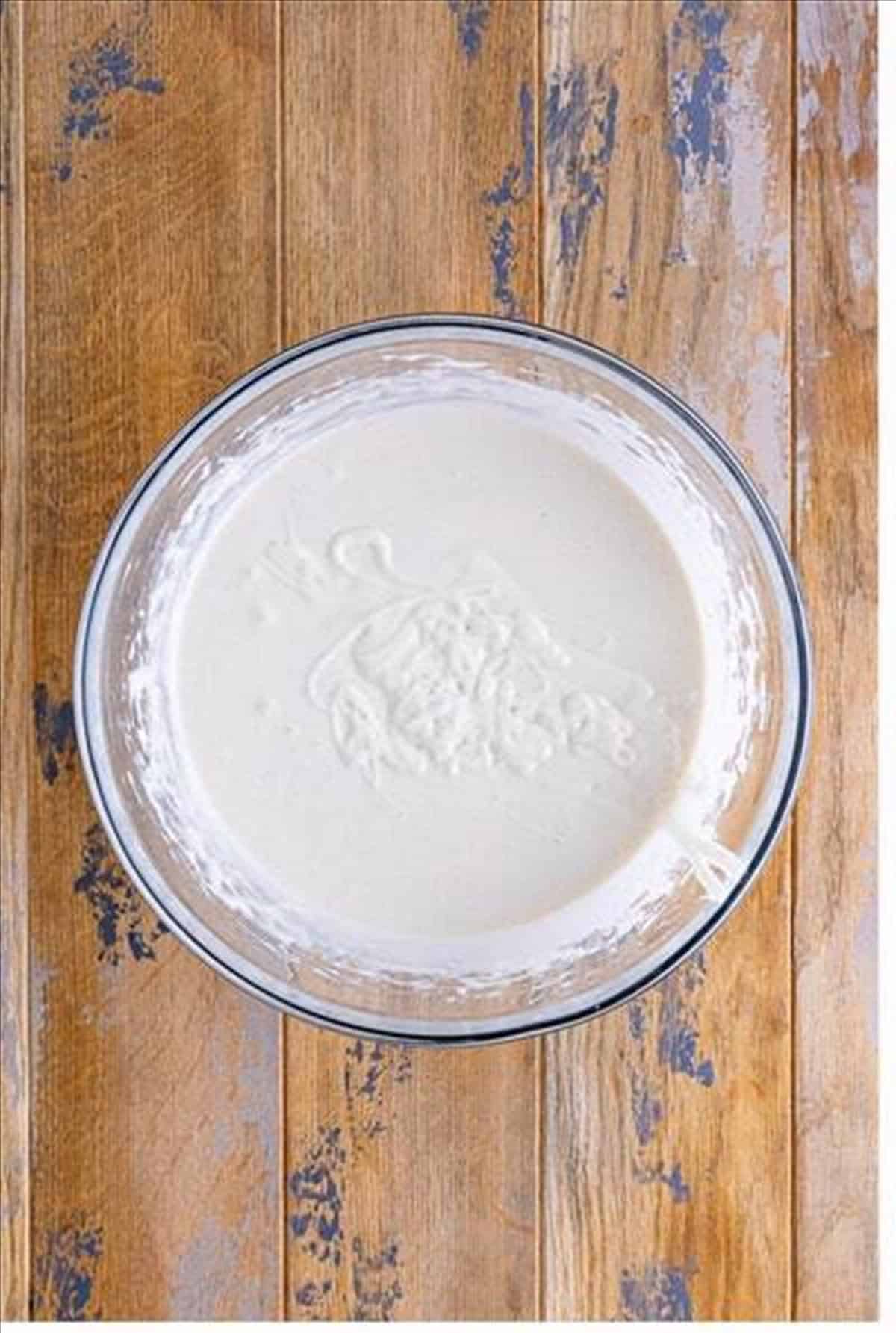 White cake mix, water, oil, and egg whites mixed into a batter for lemon blueberry poke cake.