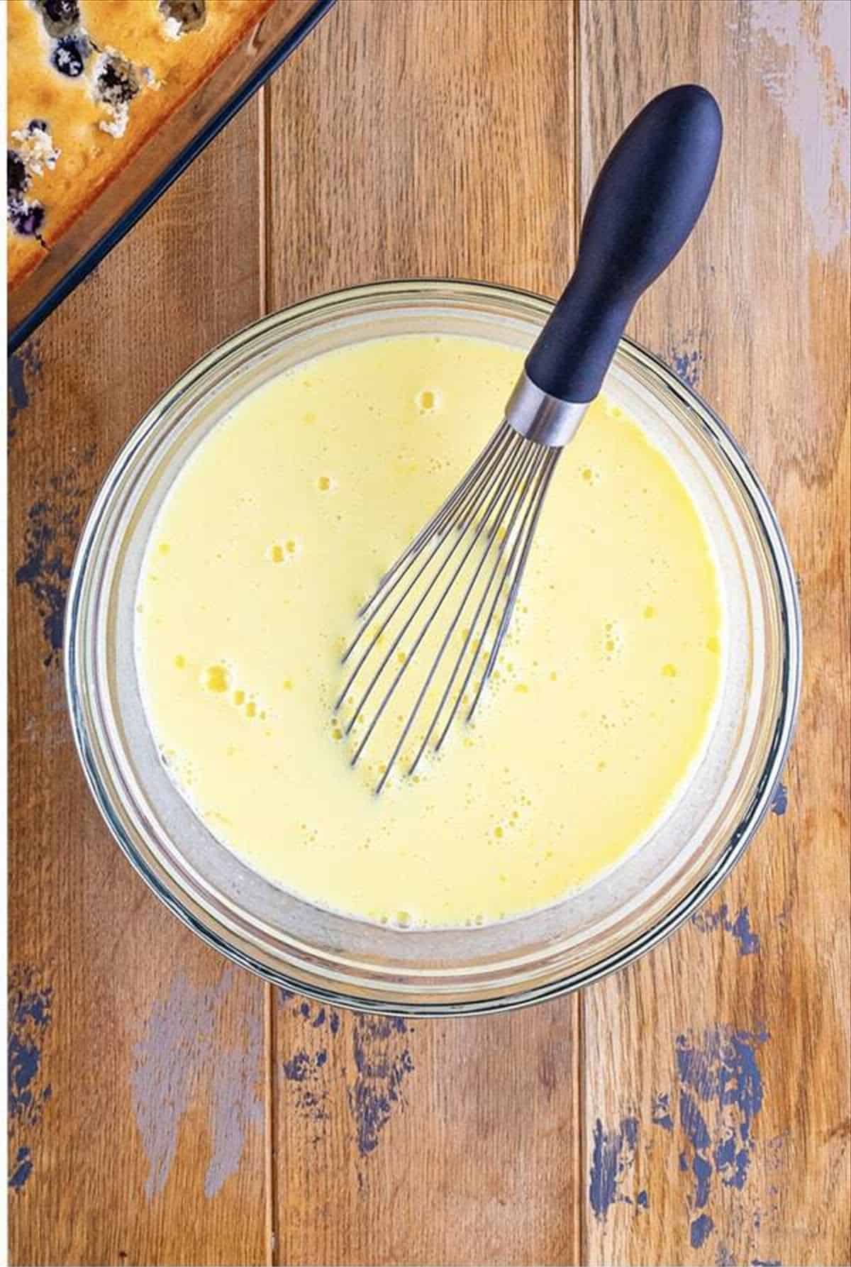 Lemon pudding whisked together in a bowl until pourable.
