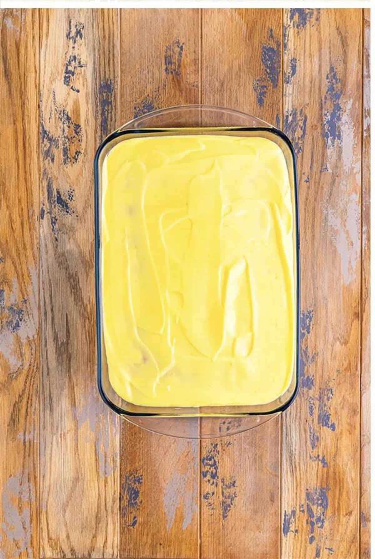 Lemon pudding poured over the poked cake.