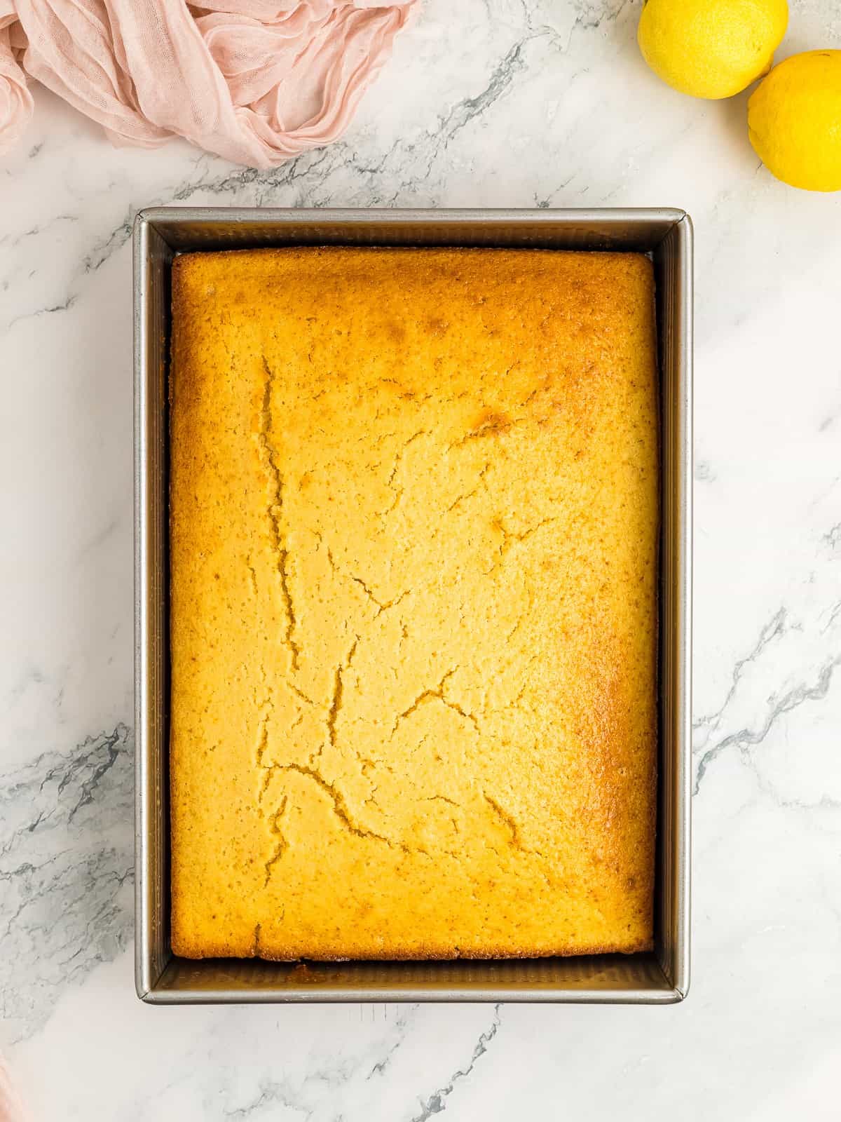 Baked lemon sheet cake in the pan.