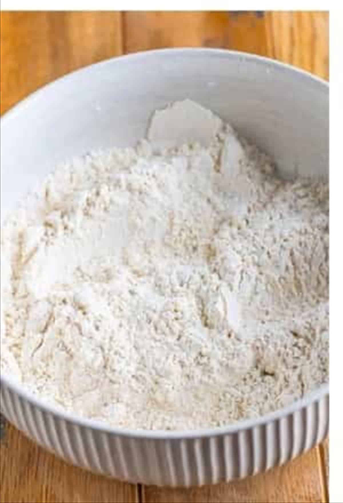 The seasoned flour dredge ready for coating the marinated chicken.
