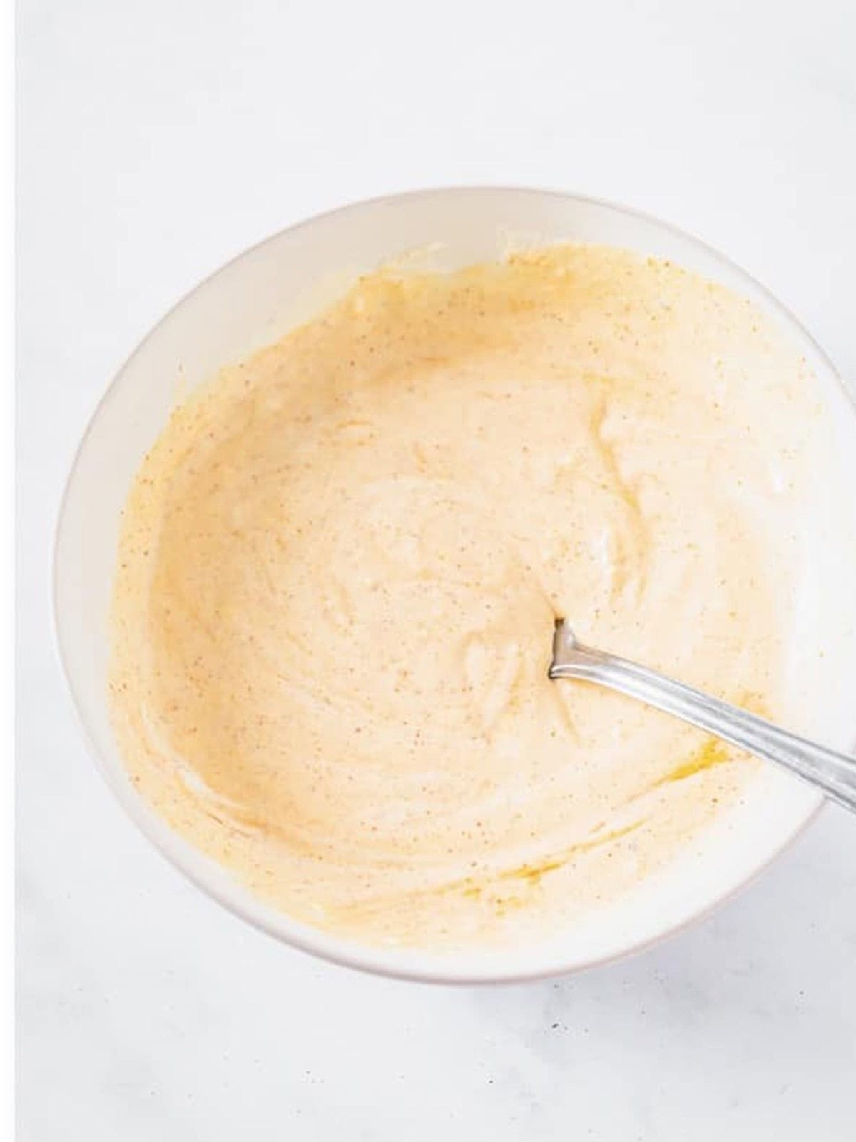 Whisking the creamy mayonnaise dressing for macaroni salad.