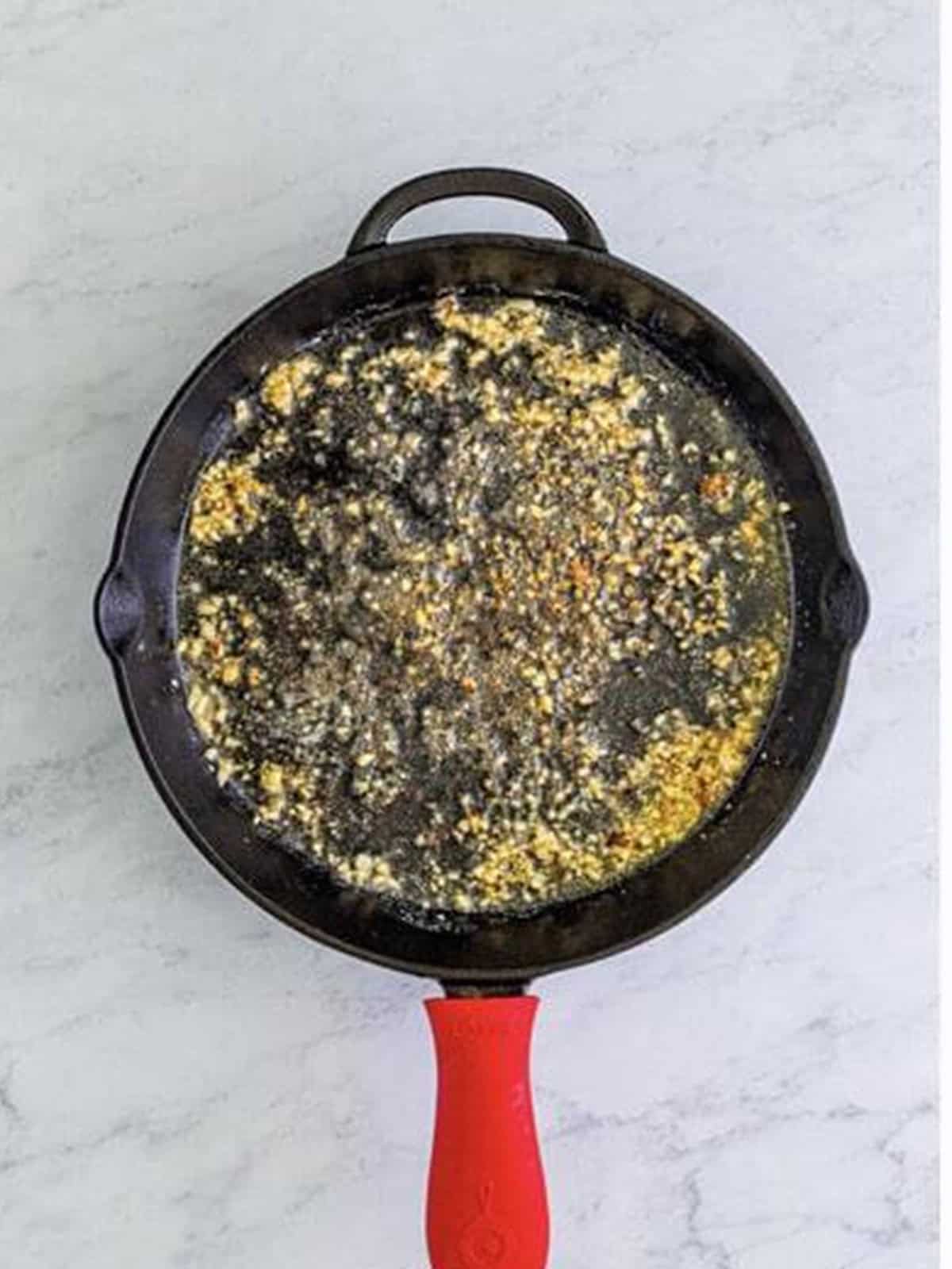 Melting butter and garlic in the skillet for Marry Me Chicken sauce.