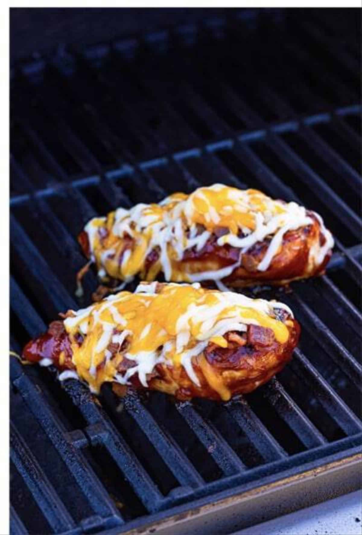 Melted cheese over the bacon and BBQ chicken on the grill.
