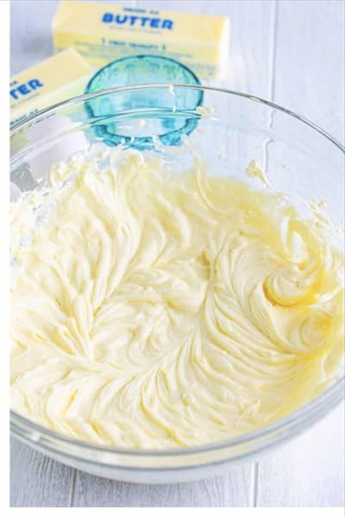 Eggs being mixed into the whipped cream cheese sugar mixture one at a time for the pineapple cheesecake batter.