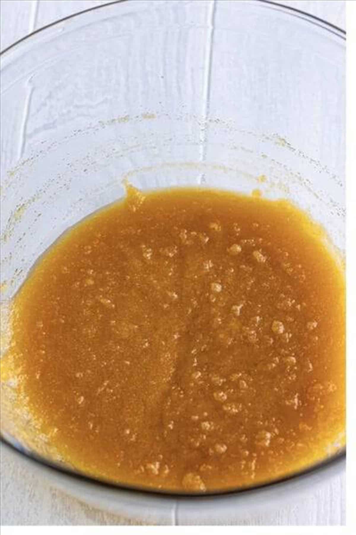 Sifted flour, baking powder, baking soda, and salt combined in a large mixing bowl for Pineapple Upside Down Cake batter.