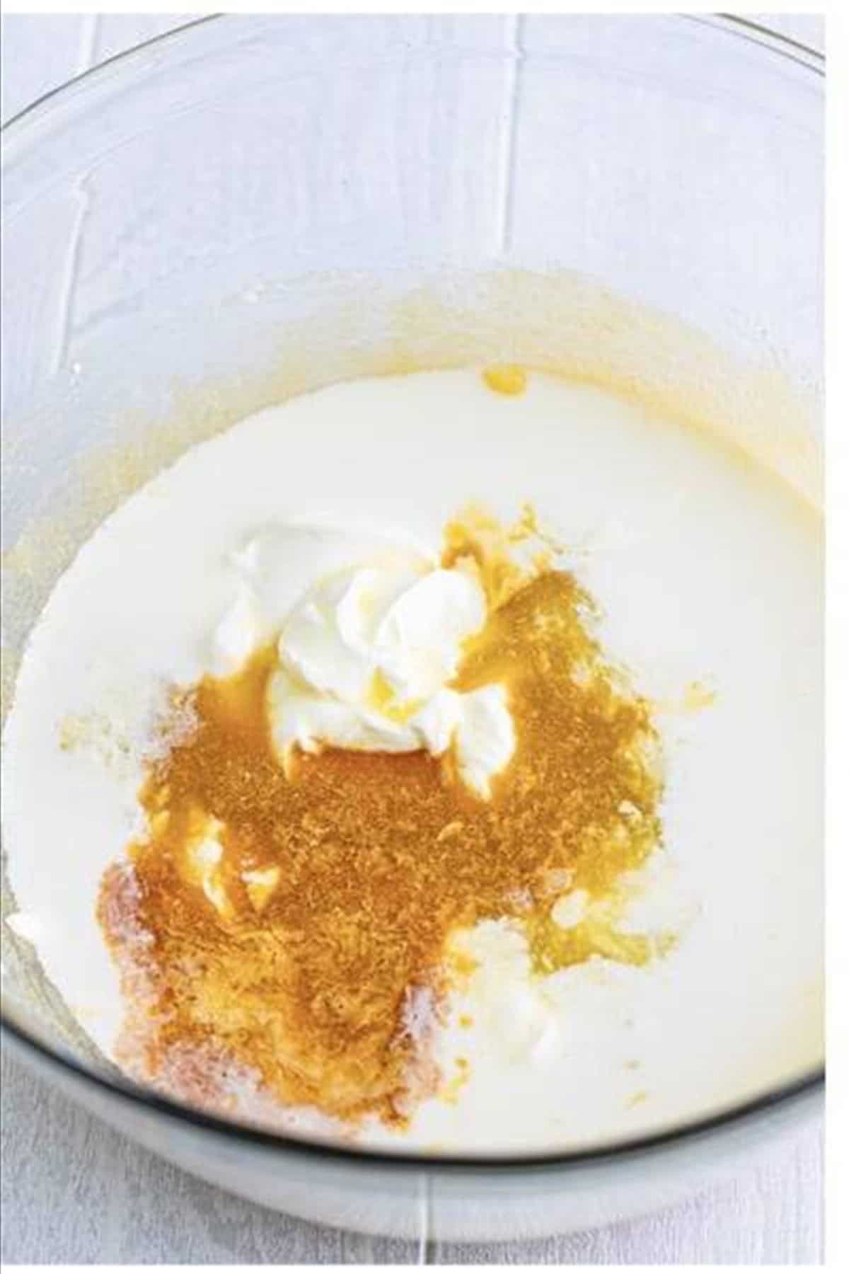 Eggs, sour cream, milk, pineapple juice, and vanilla whisked into the butter sugar mixture for the cake batter.