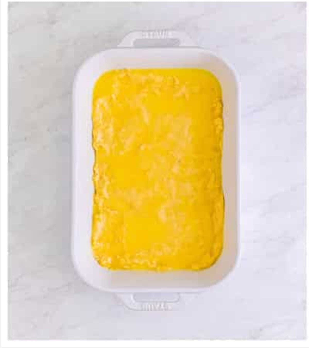 Melted butter brushed over the top of the cheese sticks dough.