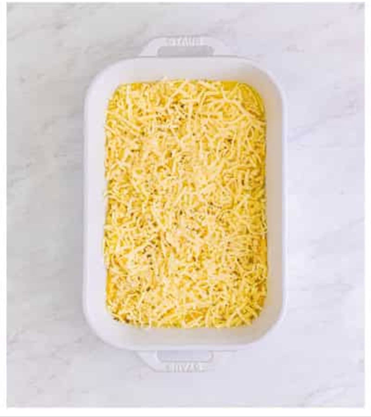 Shredded mozzarella, parmesan, and seasonings sprinkled over Pizza Hut cheese sticks dough.