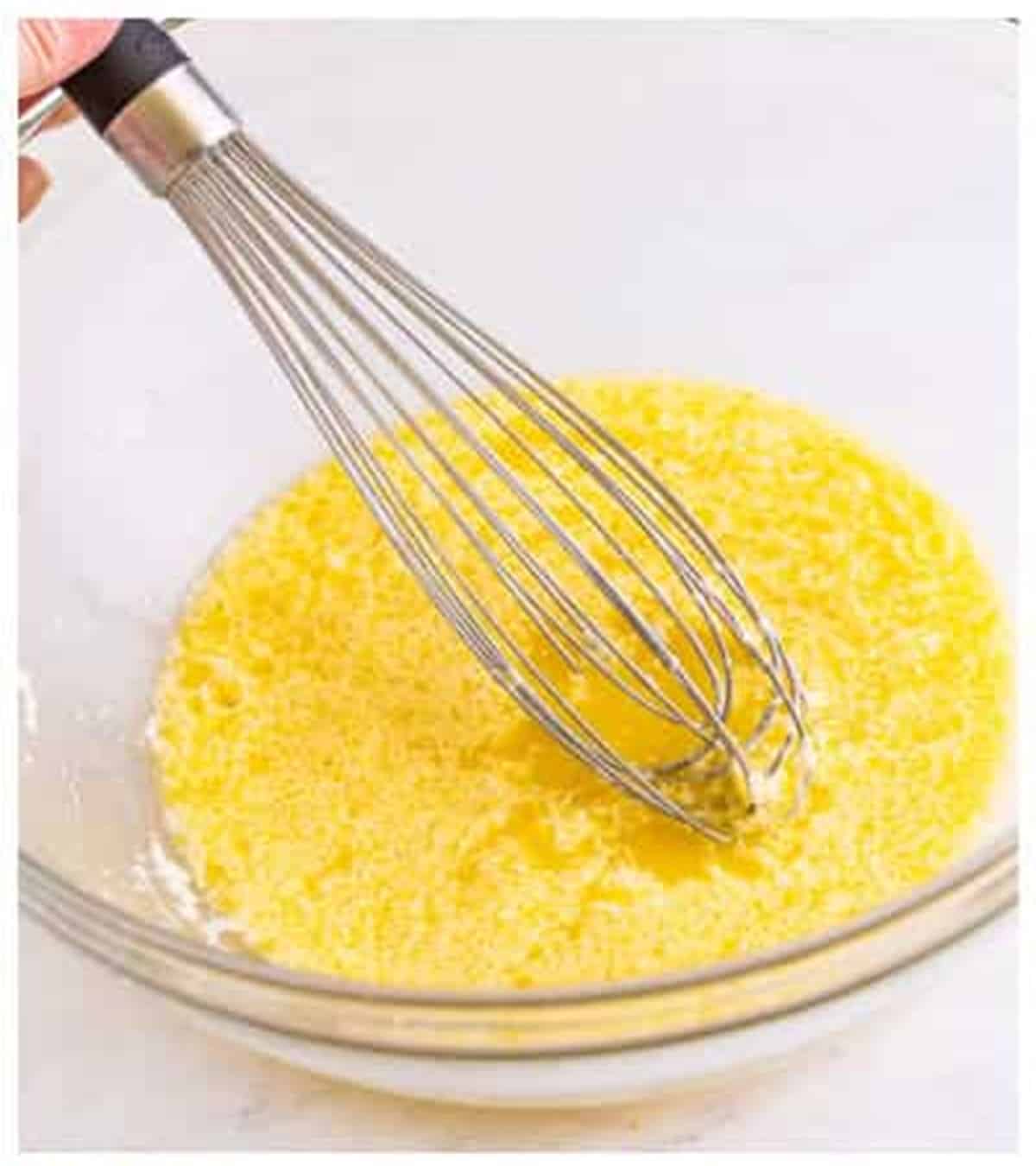 Egg yolk and yeast whisked into the butter mixture for cheese sticks dough.