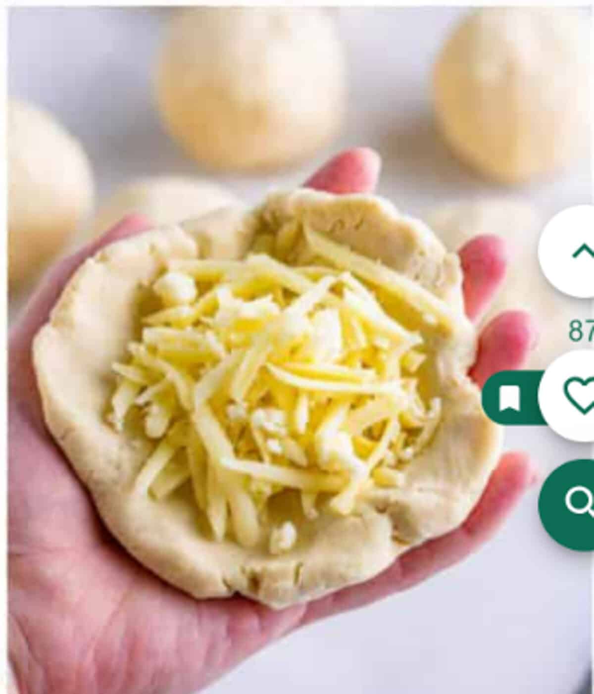 Cheese filling added to the center of a dough disc with edges being folded and pinched closed for a Pupusas Recipe.
