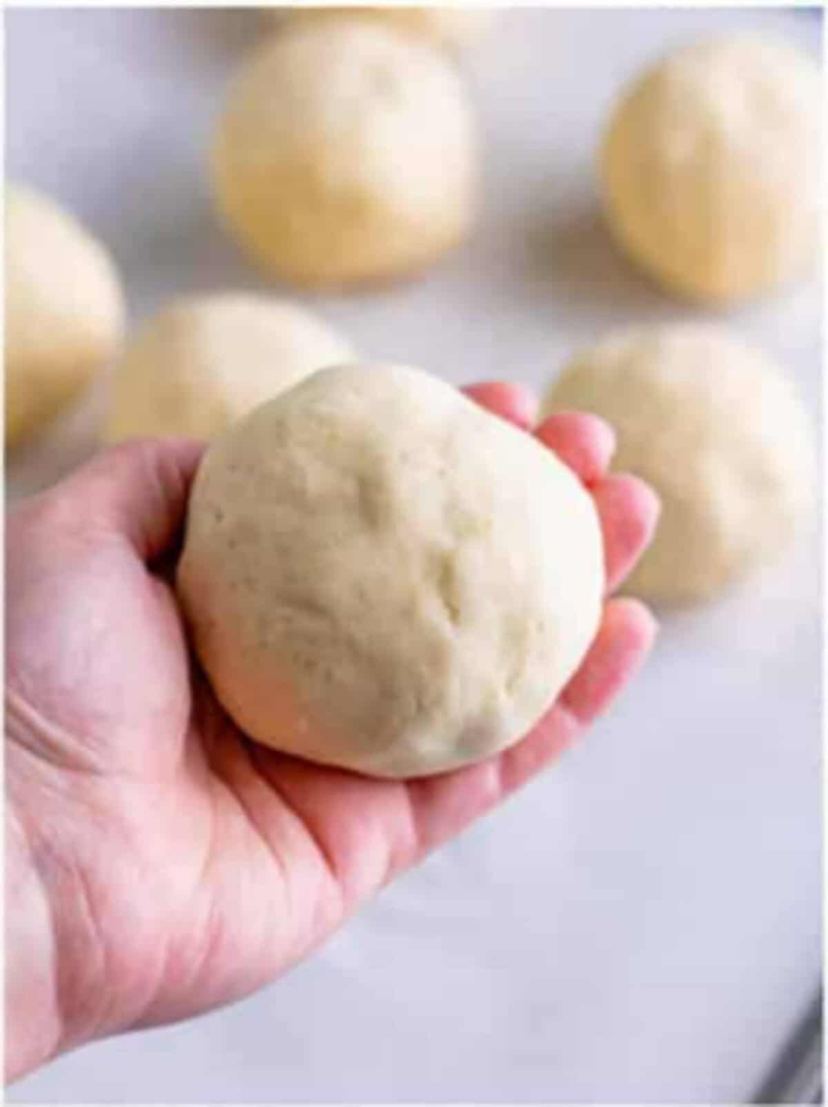 Filled pupusa being gently patted into a round disc about a quarter inch thick for a Pupusas Recipe.