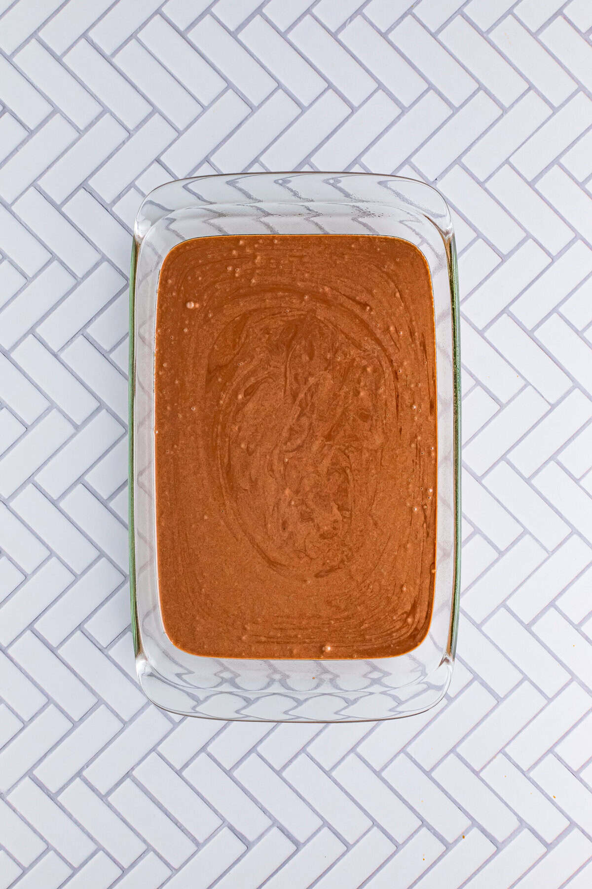 Chocolate cake batter mixed and poured into a 9x13 baking dish prepared for the Italian Love Cake Recipe.