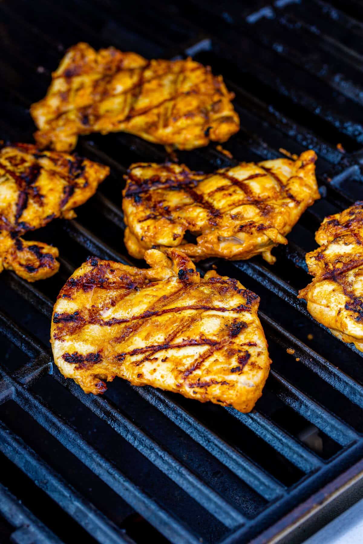 Cilantro lime rice fluffed and grilled chipotle chicken resting on the cutting board for a Chipotle Bowl Recipe.