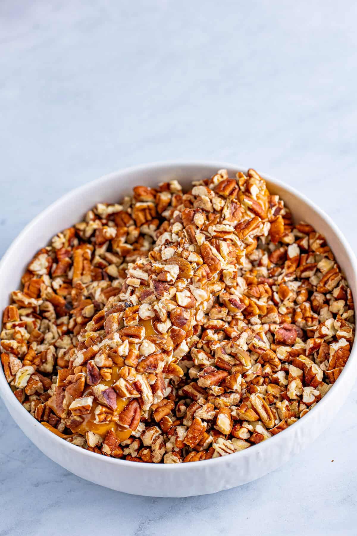 A frozen log dipped in caramel and rolled in chopped pecans.