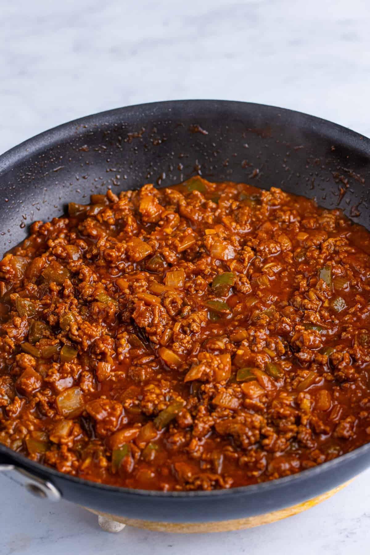 Homemade Dr Pepper sloppy joes filling fully simmered and thickened to a rich, saucy consistency in a nonstick skillet, ready to serve.