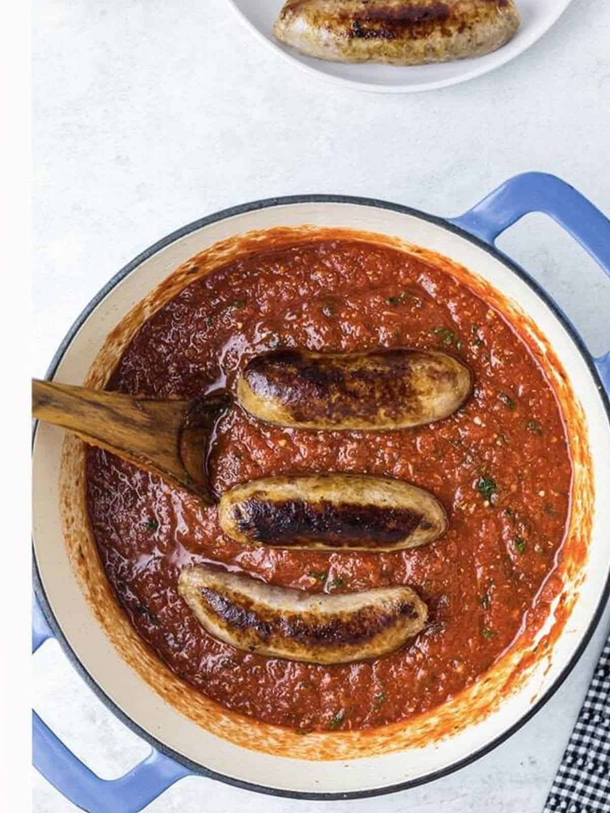The spaghetti sauce simmering with the browned Italian sausage.
