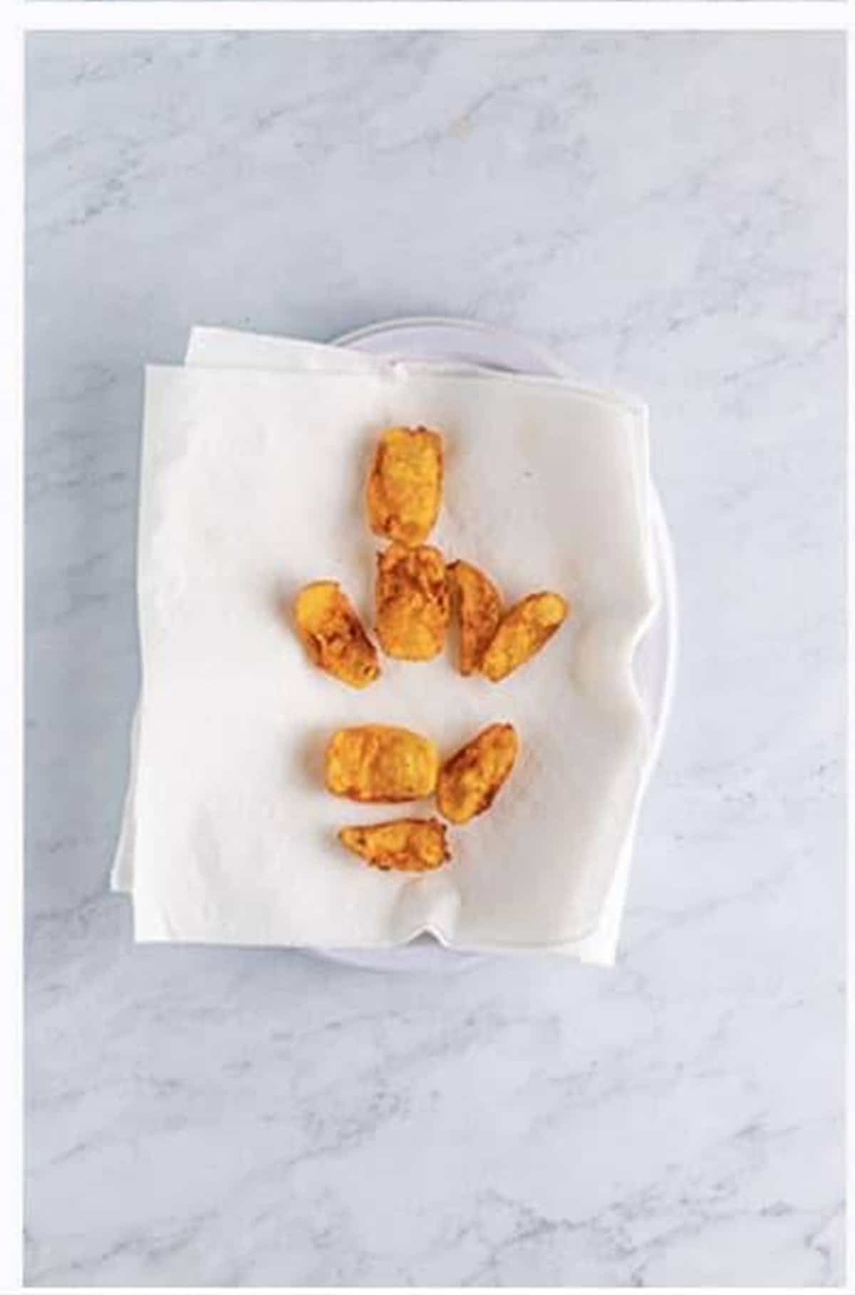Drain fried onion petals on paper towels and season immediately with seasoned salt.