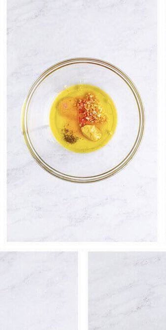 Olive oil, red wine vinegar, Dijon mustard, garlic, salt, and pepper added to a small bowl for the salad dressing.