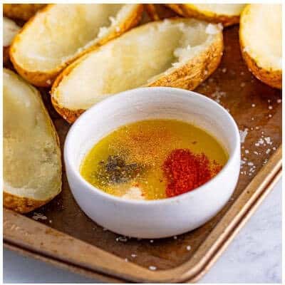 Melting butter and olive oil with garlic, onion, paprika, salt, and pepper for the seasoned brush mix.