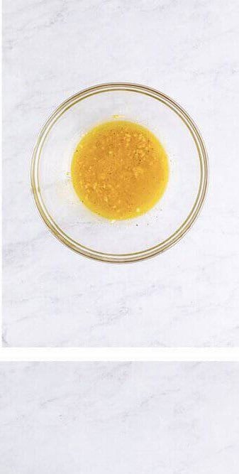 Whisking the Dijon vinaigrette dressing in a small bowl until fully emulsified.