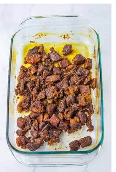Chuck roast burnt ends after the first oven roast showing a deep dark caramelized crust on every piece.