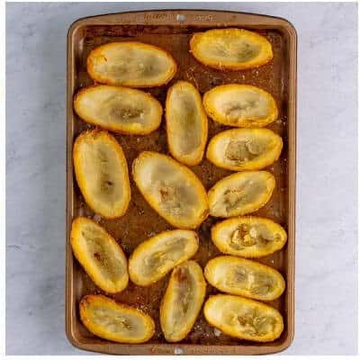 Scooped potato skins brushed with the seasoned butter-oil mix before the second bake to crisp.