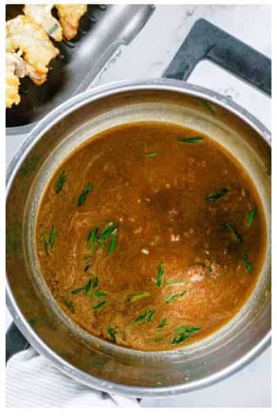 Reducing remaining Asian marinade in a saucepan into a glossy serving sauce.