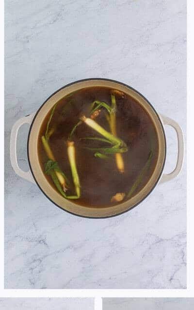 Wonton Soup broth simmering with aromatics infusing the chicken stock for 15 minutes.