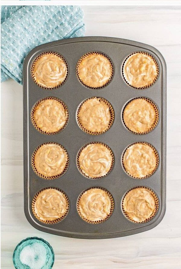 Golden Banana Cream Cheese Muffins fresh from the oven in a muffin tin.