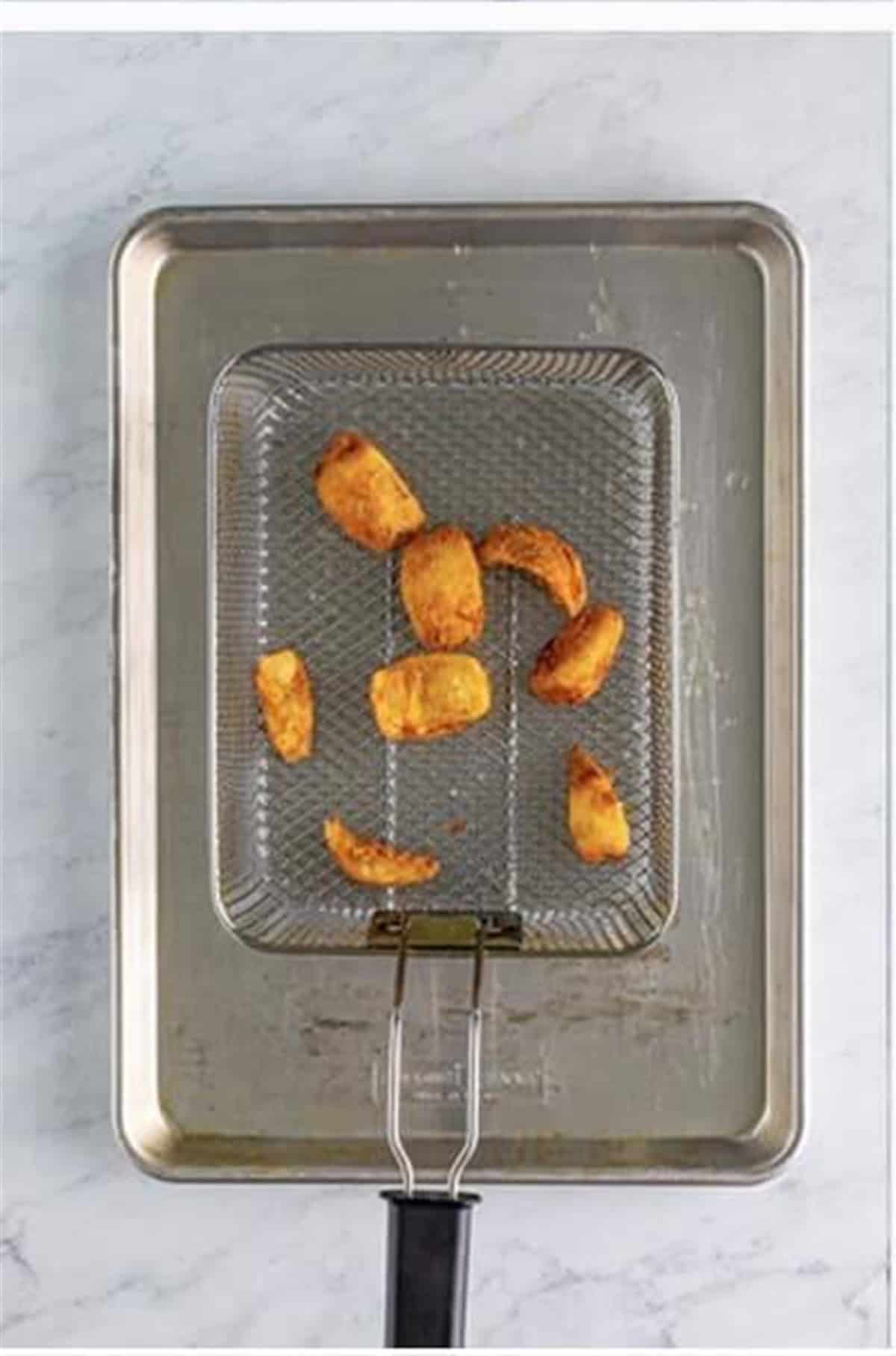 Fry breaded onion petals in 350F oil until golden brown for Crispy Onion Petals Recipe.