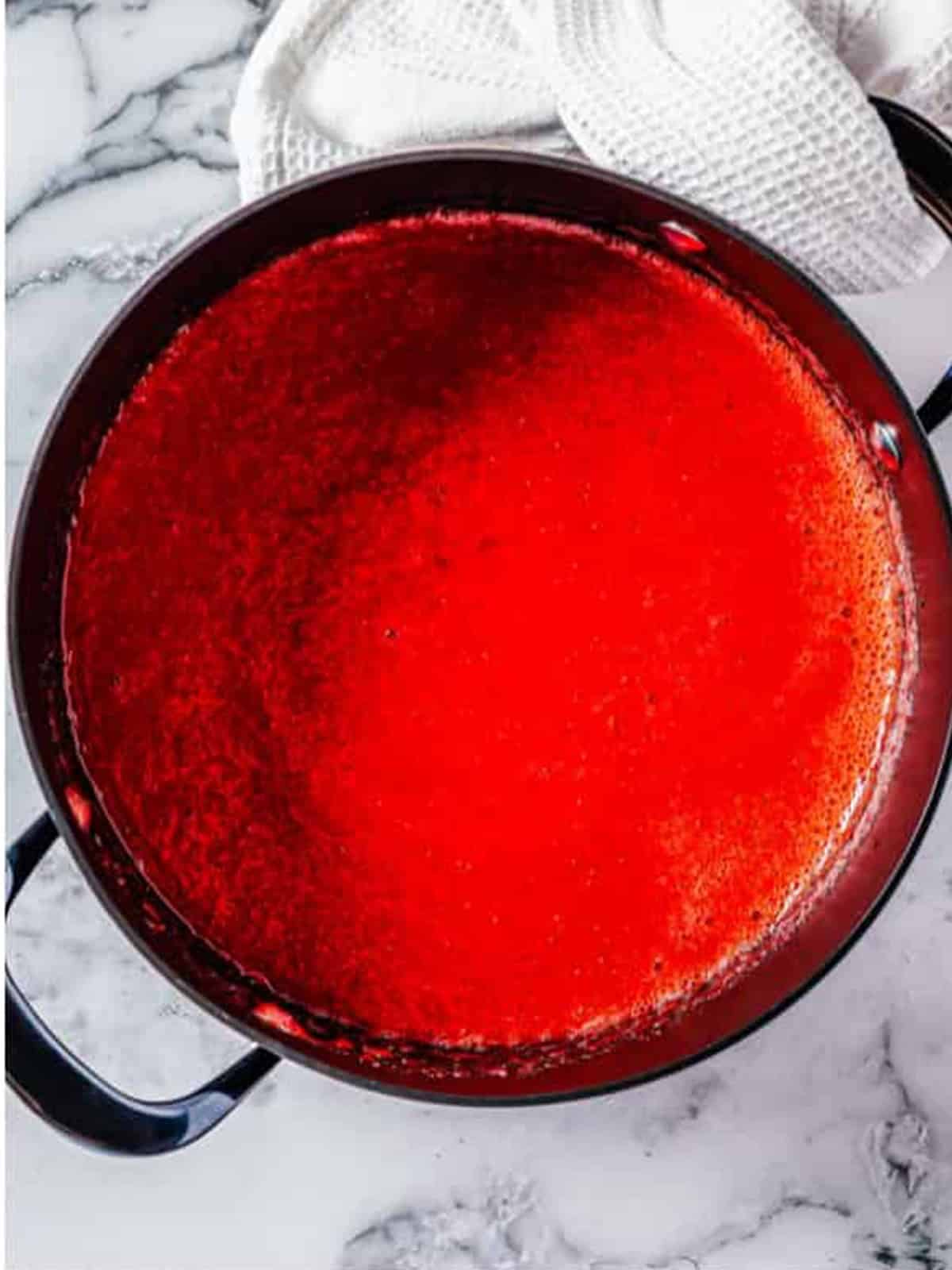 The smooth strawberry mixture simmering in the pot.