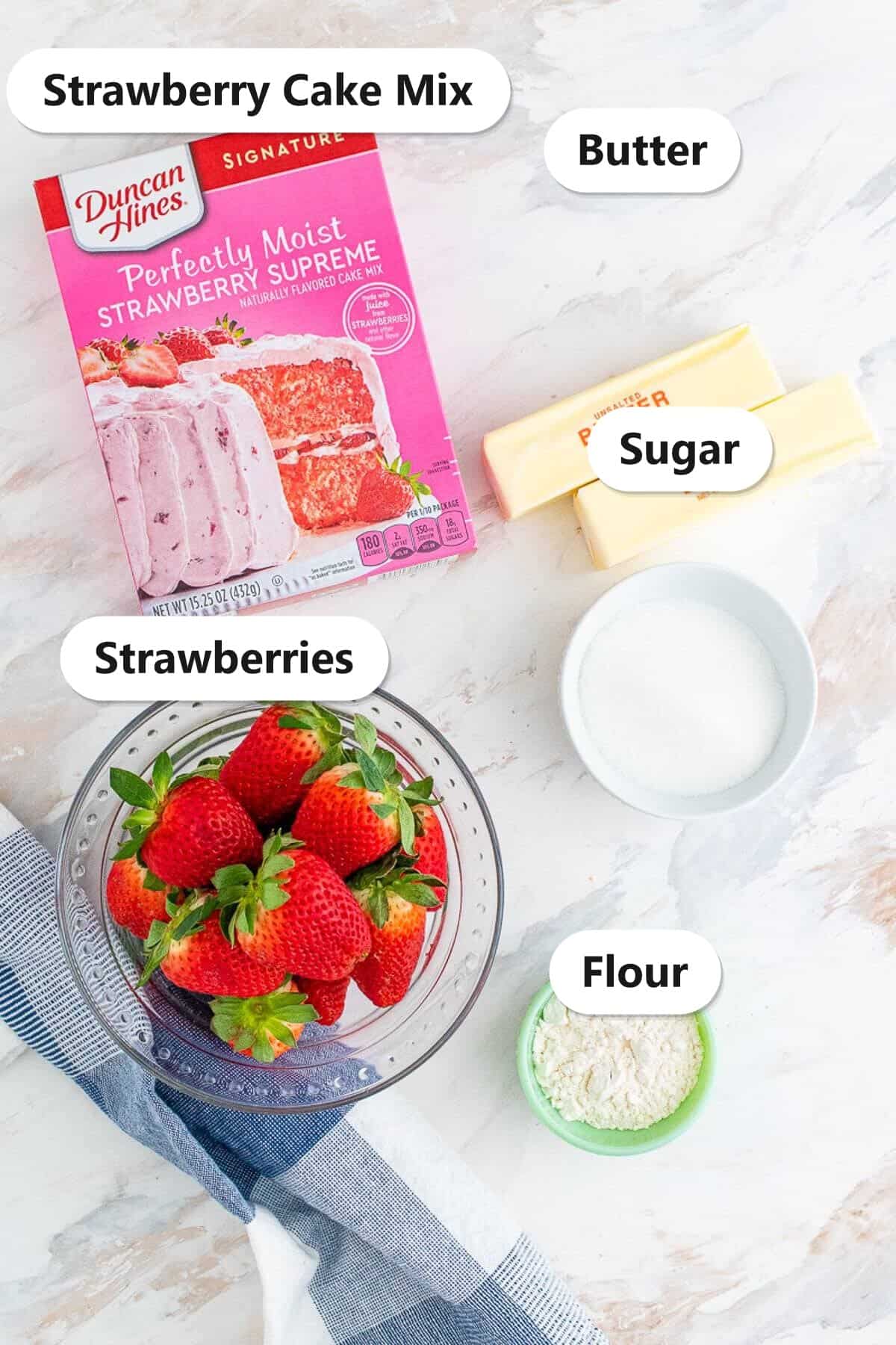 Strawberry Dump Cake ingredients labeled including fresh strawberries, strawberry cake mix, butter, sugar, and flour.