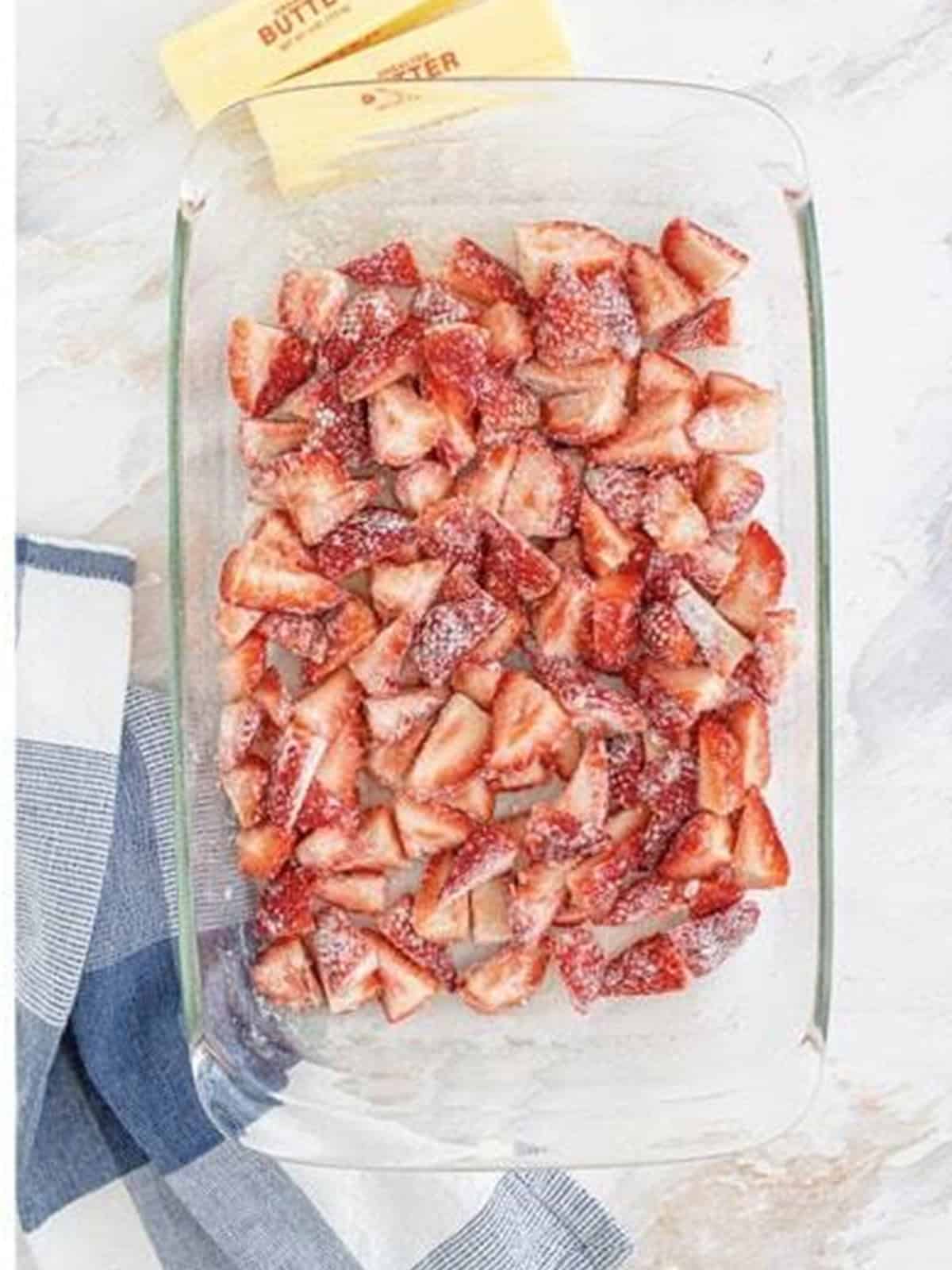 Strawberries stirred and coated in the sugar and flour.